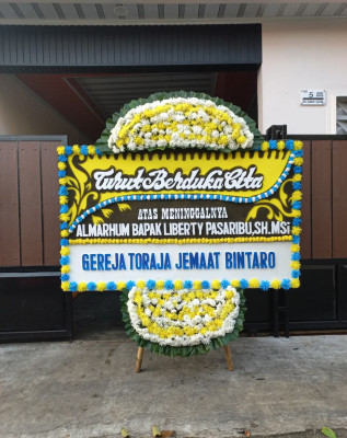 Papan Bunga Duka di Beo
